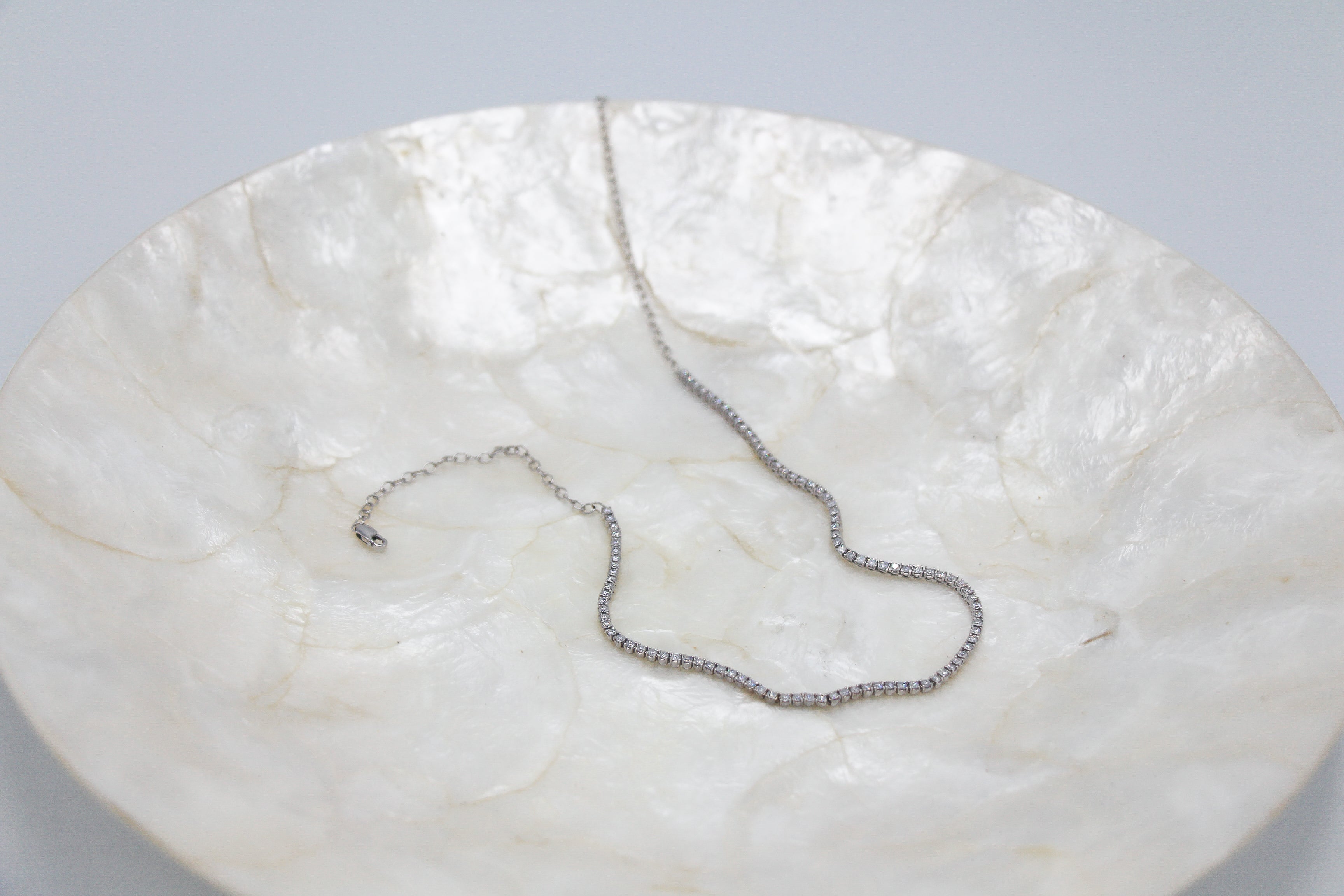 Diamond tennis necklace on a plate