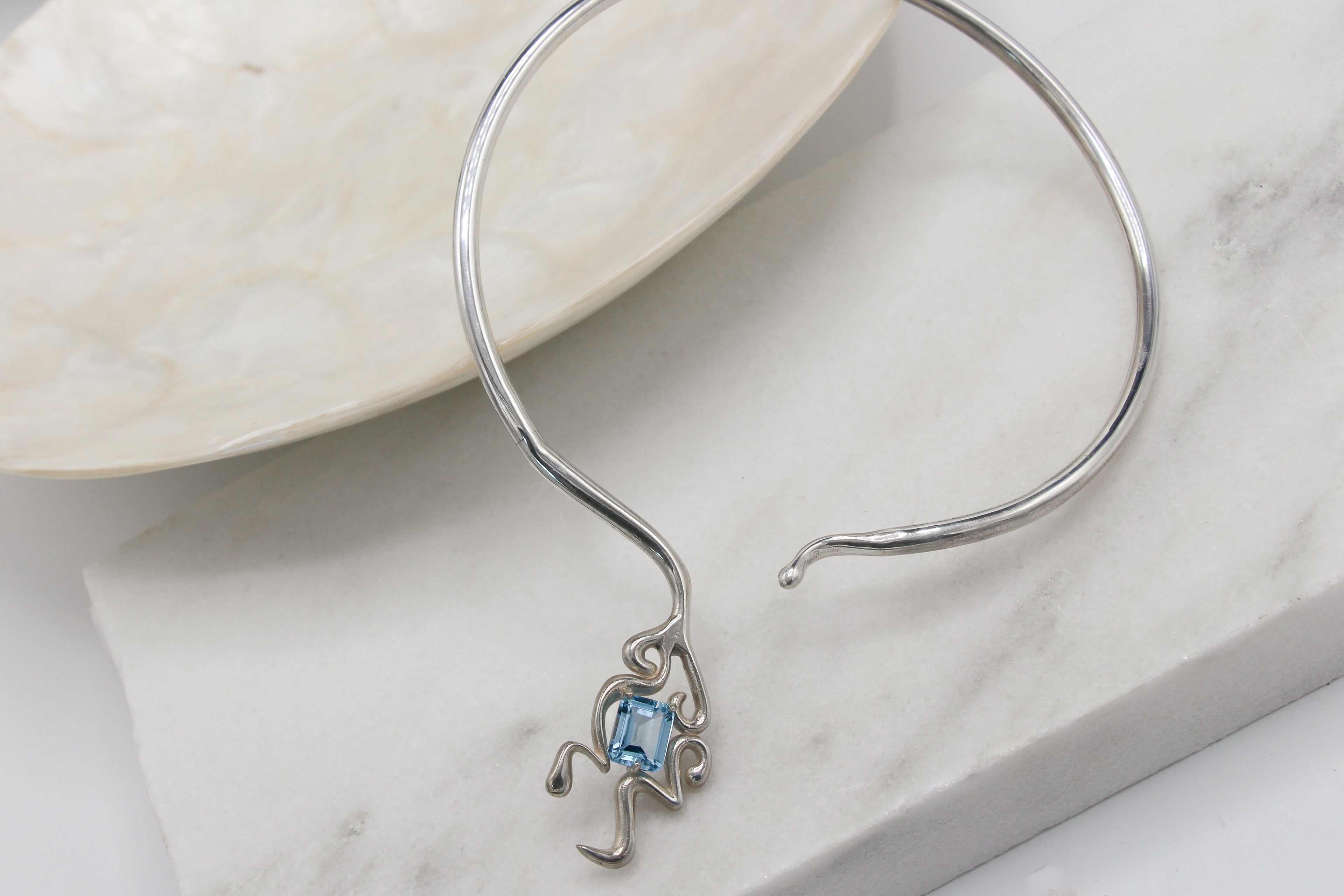 White gold collar necklace with emerald cut aquamarine 