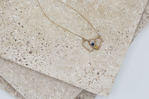 Intertwining two hearts with citrine and blue sapphire gemstones