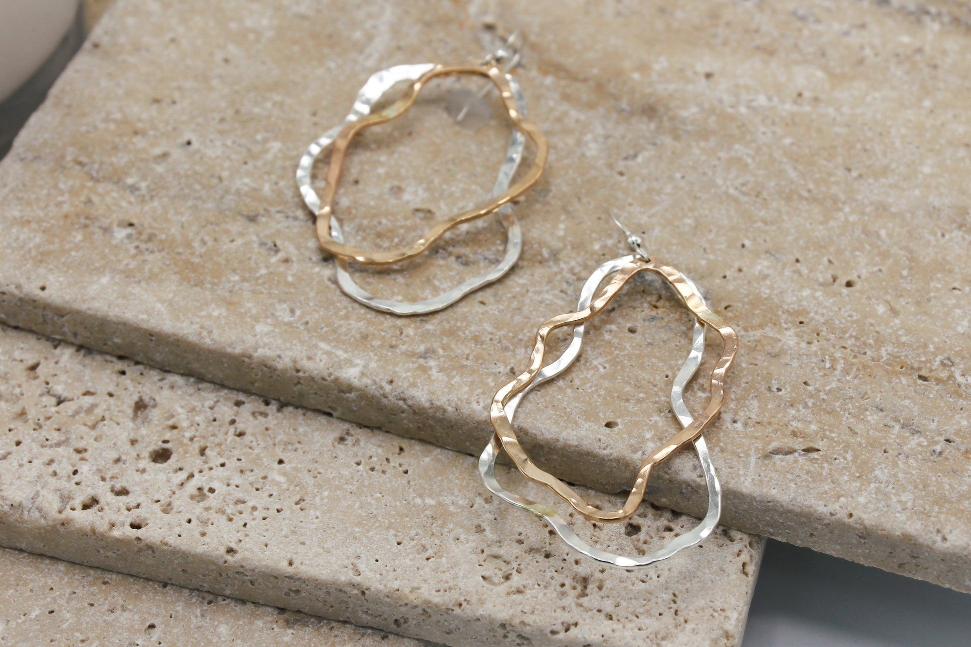 Two toned dangle earrings with overlapping organic hammered shapes