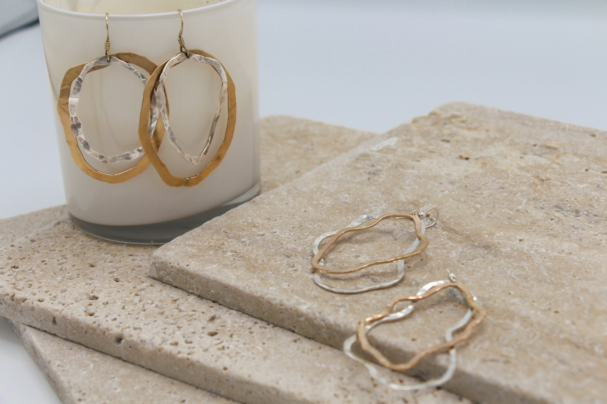 Gold filled and sterling silver organic hammered shapes stacked on a hook earring for movement 