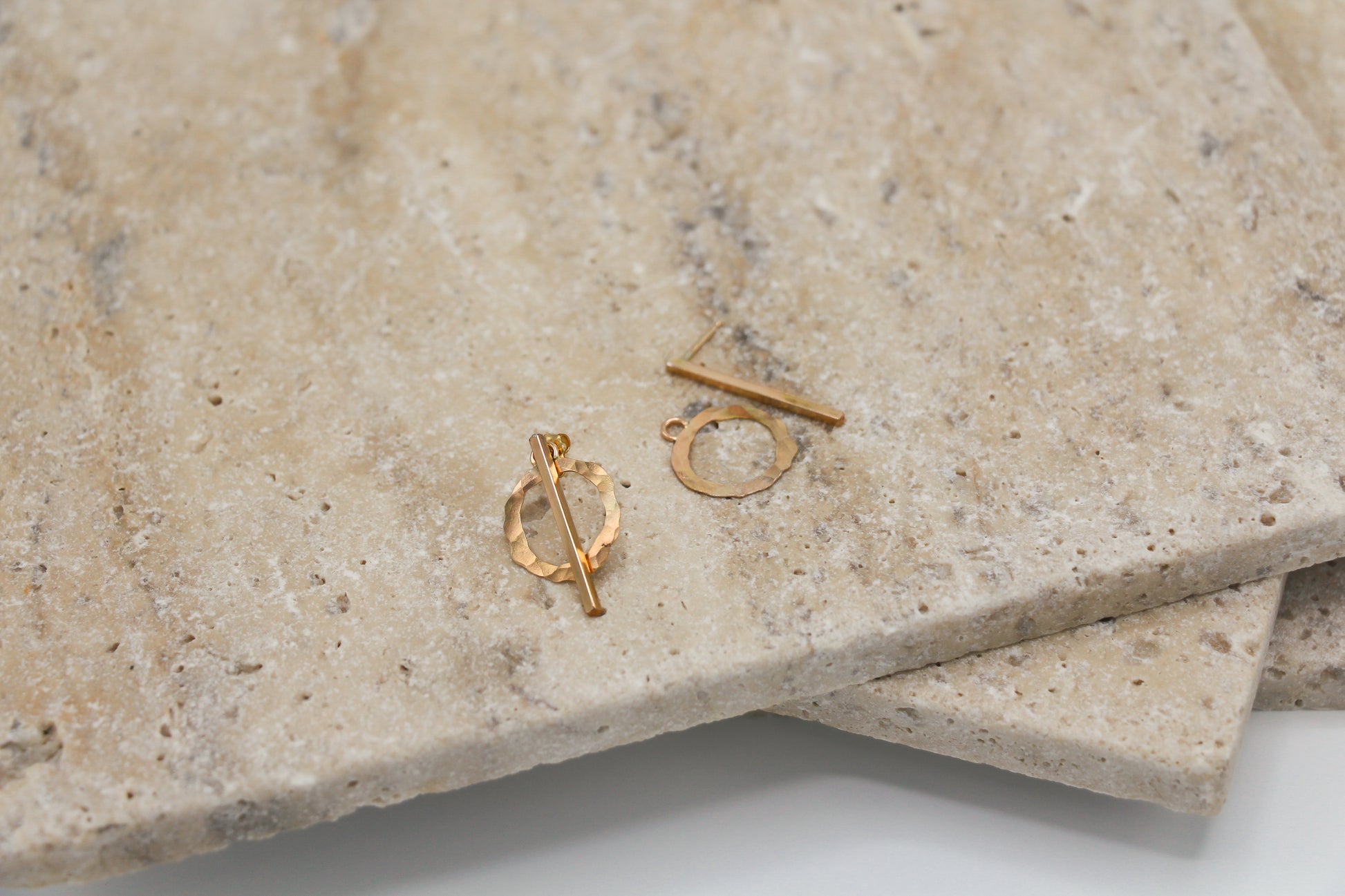Suz Earrings featuring a bar stud and a hammered circle ear jacket.